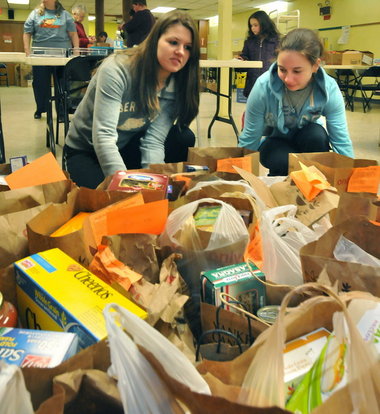 students from South Hadley High School come together to collect food items .  