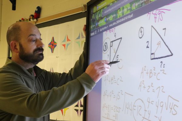 Math teacher Scott Dion utilizes a digital TouchView to demonstrate the Pythagorean theorem to students.