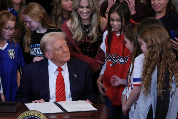 U.S. President Donald Trump sits to sign an executive order banning transgender girls and women from participating in women's sports, in the East Room at the White House in Washington, U.S., February 5, 2025. REUTERS/Leah Millis