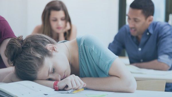 Student sleeping in class because she is tired.